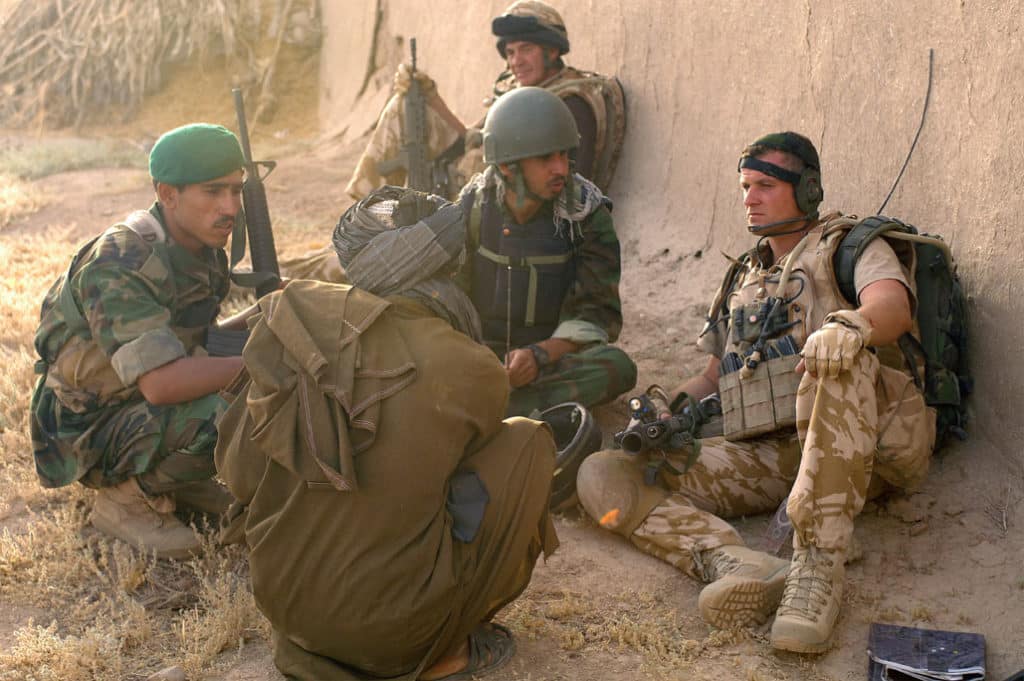 KAJAKI, Afghanistan – British Sgt. Rab McEwan, Kajaki Operational Mentoring Liaison Team, discusses the local situation with a local resident via a translator and Afghan National Army soldier during a patrol north of the Kajaki Dam here June 17, 2008. The ANA soldiers work closely with the British soldiers of the OMLT, which provides mentorship and liaison assistance with ISAF. The ISAF soldiers are responsible for the security of the dam as well as working with the Afghan National Army and Afghan National Police to assist in security for local villages. The dam provides electricity for the majority of Helmand province and Kandahar as well as irrigation control for the region. (ISAF photo by Staff Sgt. Jeffrey Duran, U.S. Army)